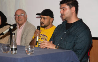Three speakers on a panel.