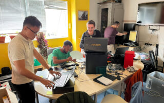 Asylum Welcome volunteers refurbishing laptops.