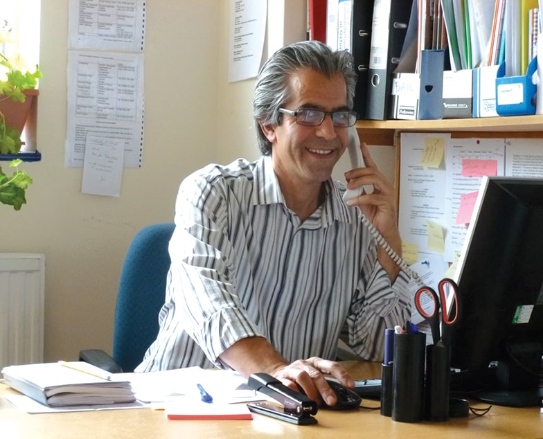 Navid (3) Navid at his desk, on the phone.